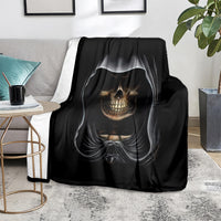 Black skull graphic blanket on couch, grinning skull centered with flowing hood details