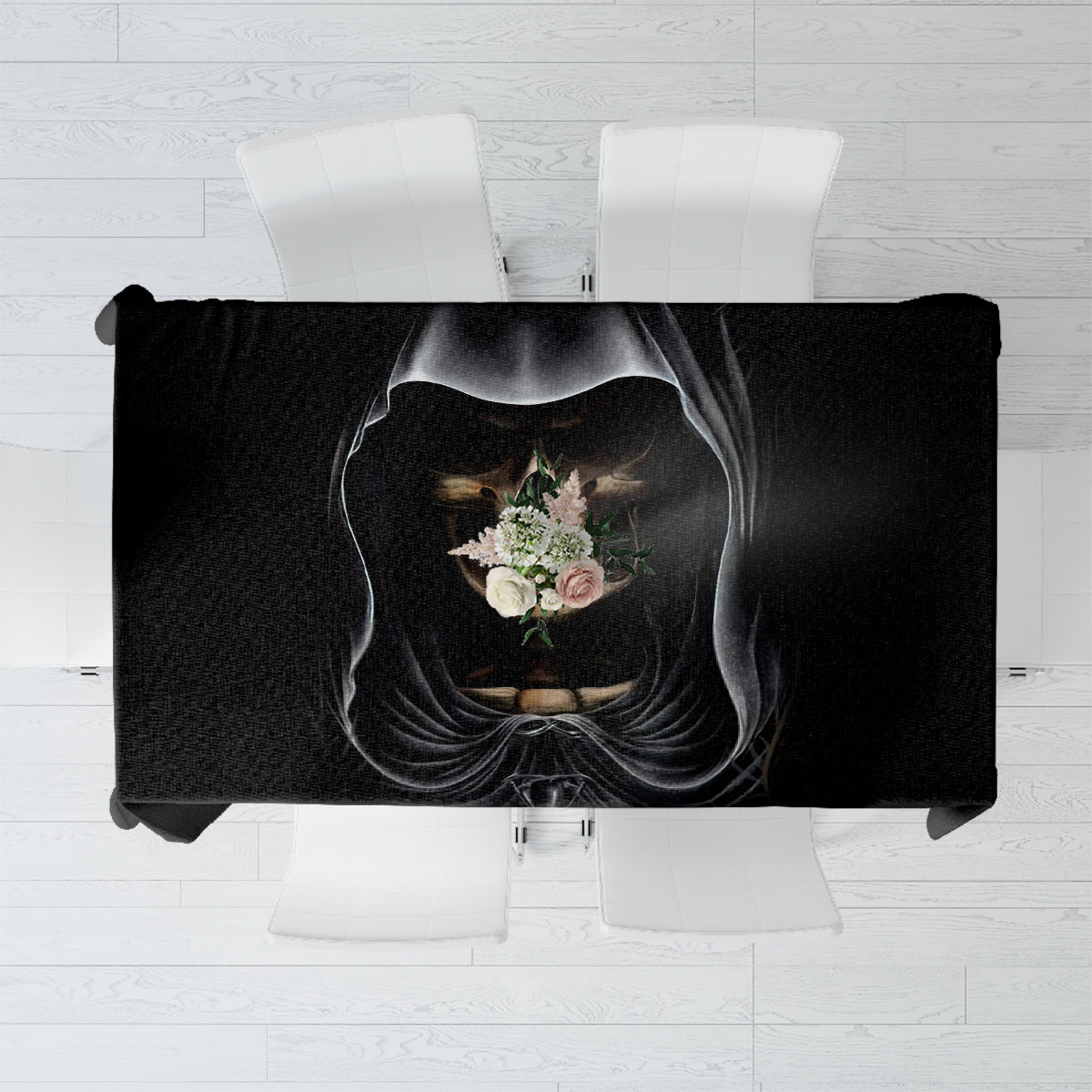 Black tablecloth featuring hooded skull portrait with floral accents, laid flat