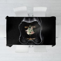 Black tablecloth featuring hooded skull portrait with floral accents, laid flat
