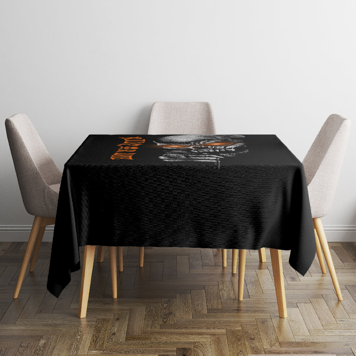 Black square tablecloth with skull graphic and orange text across the front