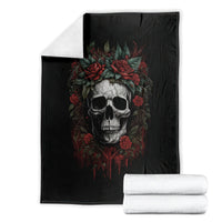 Black skull blanket with red rose wreath, shown folded with white towels