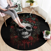 Black round skull rug with red rose drips and green leaves, corner view.