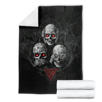 Black skull graphic blanket with red glowing eyes, folded display with rolled white towels