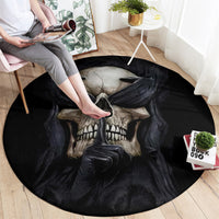 Black round rug with skull and wings motif, shown in use