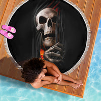 Black circular beach blanket with skull-and-skeleton flames graphic and white fringed border