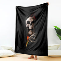 Black skull throw blanket with skeletal hands and fiery flame graphic