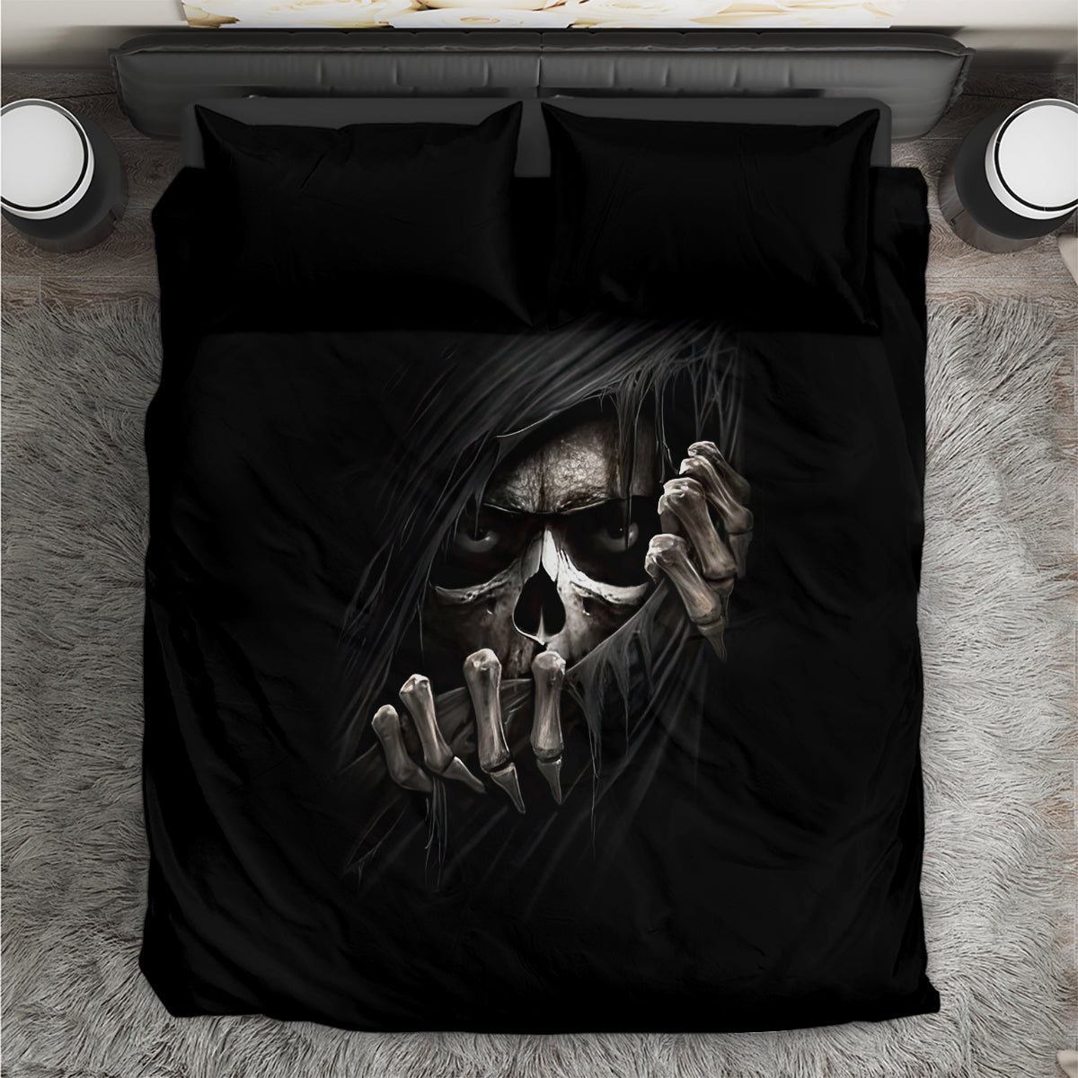Black bedding set with skull face and hands graphic on duvet and matching pillowcases