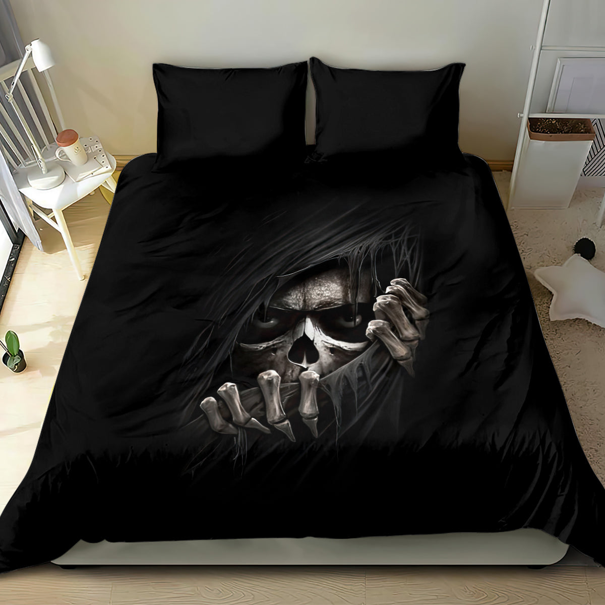 Black bedding set with skull face and bony hands graphic on duvet and pillowcases