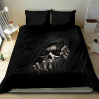Black bedding set with skull face and bony hands graphic on duvet and pillowcases