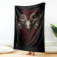 Black skull-and-wings throw blanket with red central emblem, fully draped over surface.