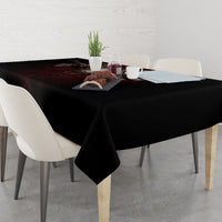 Black skull tablecloth on dining table with chairs and table setting