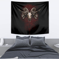 Black skull tapestry hanging above bed with red pentagram and winged skull design