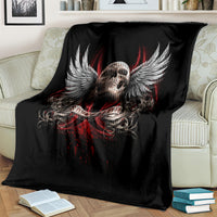 Black skull and wings graphic blanket, draped over couch with full design visible