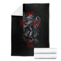 Black blanket displayed with folded white towels, gray crusader skull graphic with red