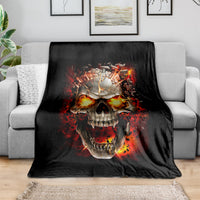 Black skull graphic blanket with fiery flame explosion design, draped on sofa
