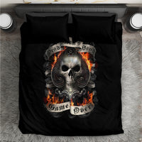 Black bedding set with skull graphic and flames on duvet, matching black pillows