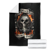 Black skull graphic blanket with flaming skull, folded with white towels