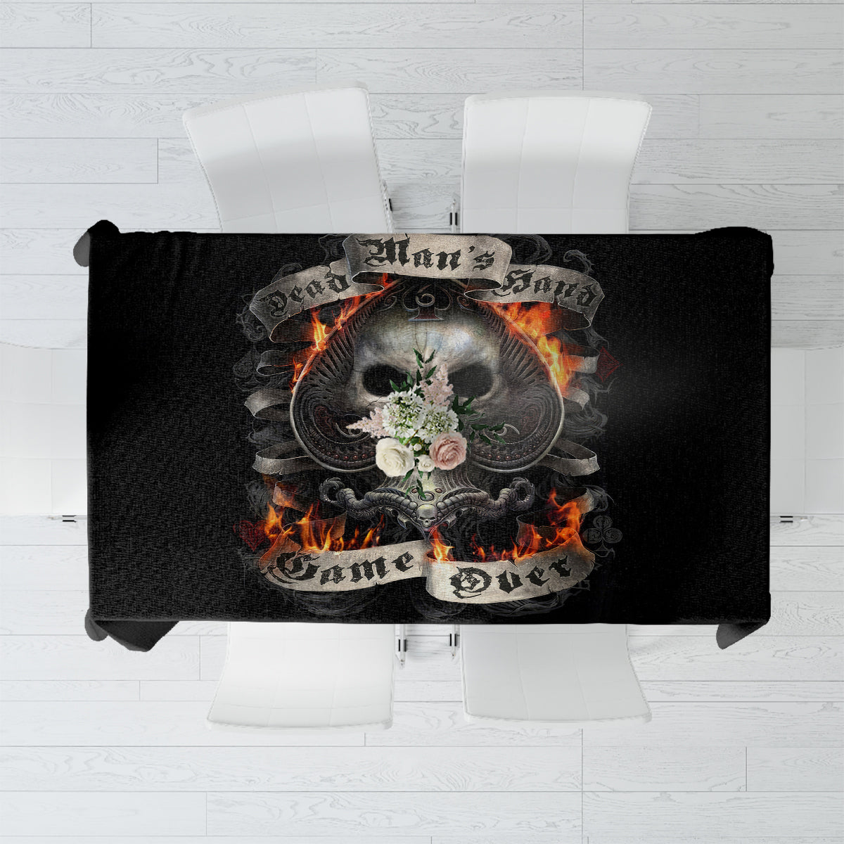Black tablecloth with skull and flames graphic, folded fabric edge visible.