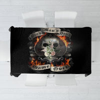 Black tablecloth with skull and flames graphic, folded fabric edge visible.