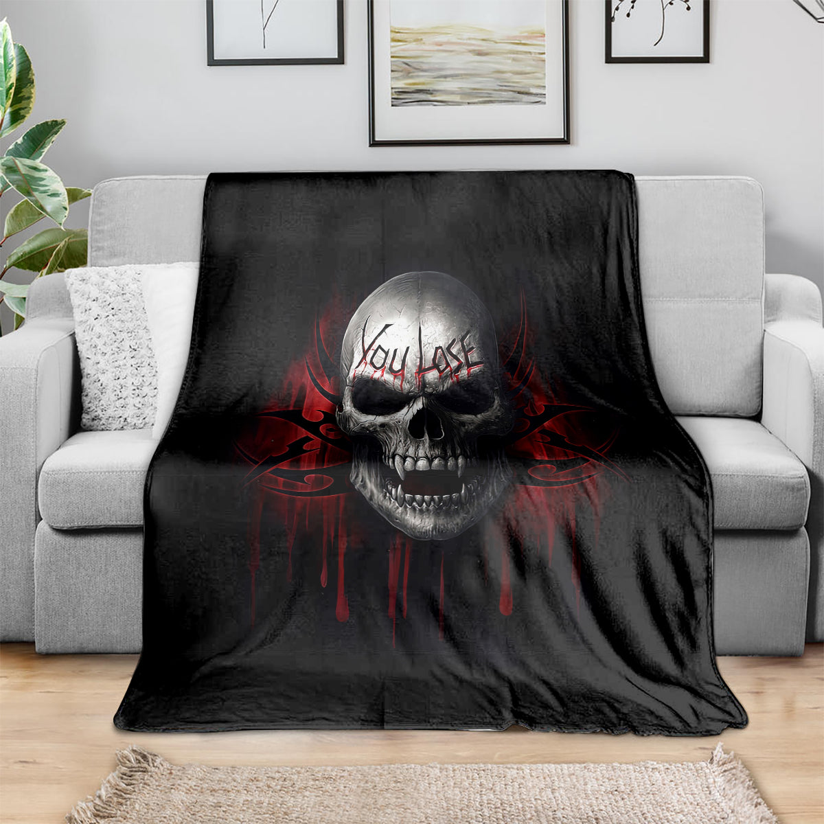 Black skull graphic throw blanket draped over a sofa