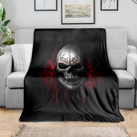 Black skull graphic throw blanket draped over a sofa
