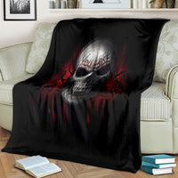 Black skull graphic throw blanket with red swirl accents