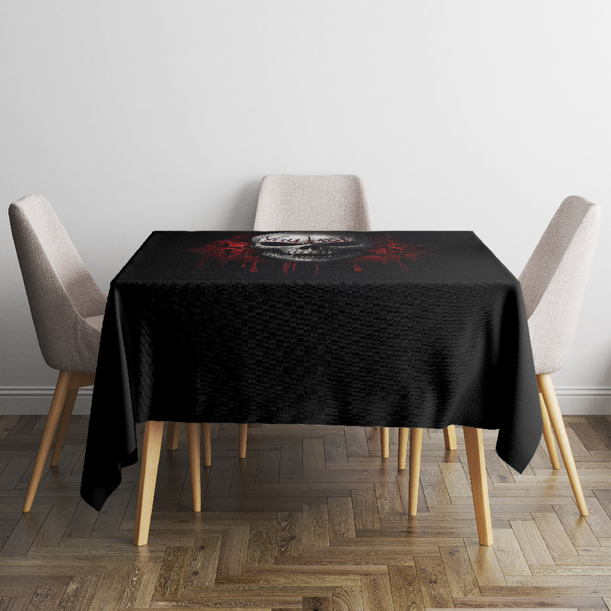 Black skull graphic tablecloth on a square table with four beige chairs