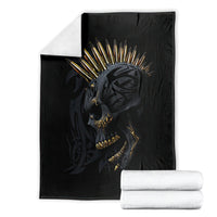 Black skull gang blanket folded with golden crown skull graphic and stacked white towels