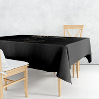 Black tablecloth draped over table with gold skull artwork along top edge