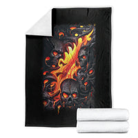Black blanket with flaming skull graphic, laid flat with folded stacks