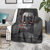 Black skull themed throw blanket covering sofa, metal skull with stars and red eye highlights
