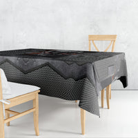 Black tablecloth draped on table with skull motif center and textured weave