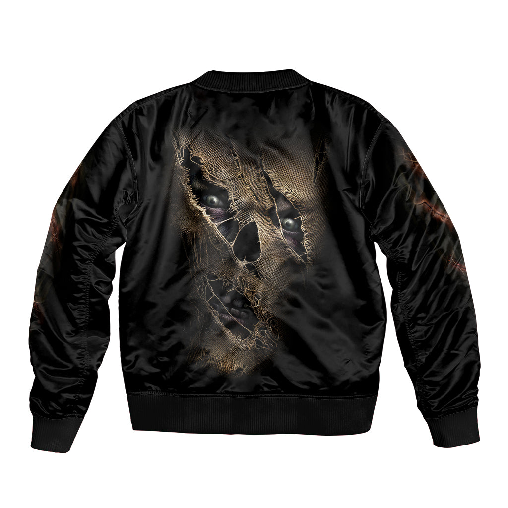 Black bomber jacket with ribbed hem and large gold mummy face graphic on back