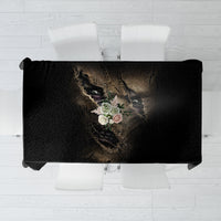 Black rectangular tablecloth with mummy skull face graphic and floral accents