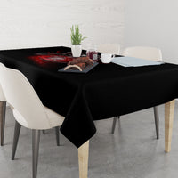 Black dining tablecloth with red skull graphic at center