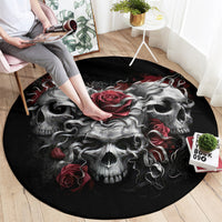 Black round skull rug with central gray skull face and red rose accents