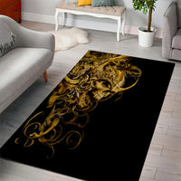 Rectangular black and gold skull area rug with detailed ornamental swirls
