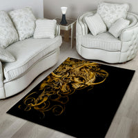 Rectangular black area rug with gold skull and filigree swirl artwork