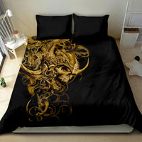 Black bedding set with golden skull graphic and ornate curls; two pillowcases on bed