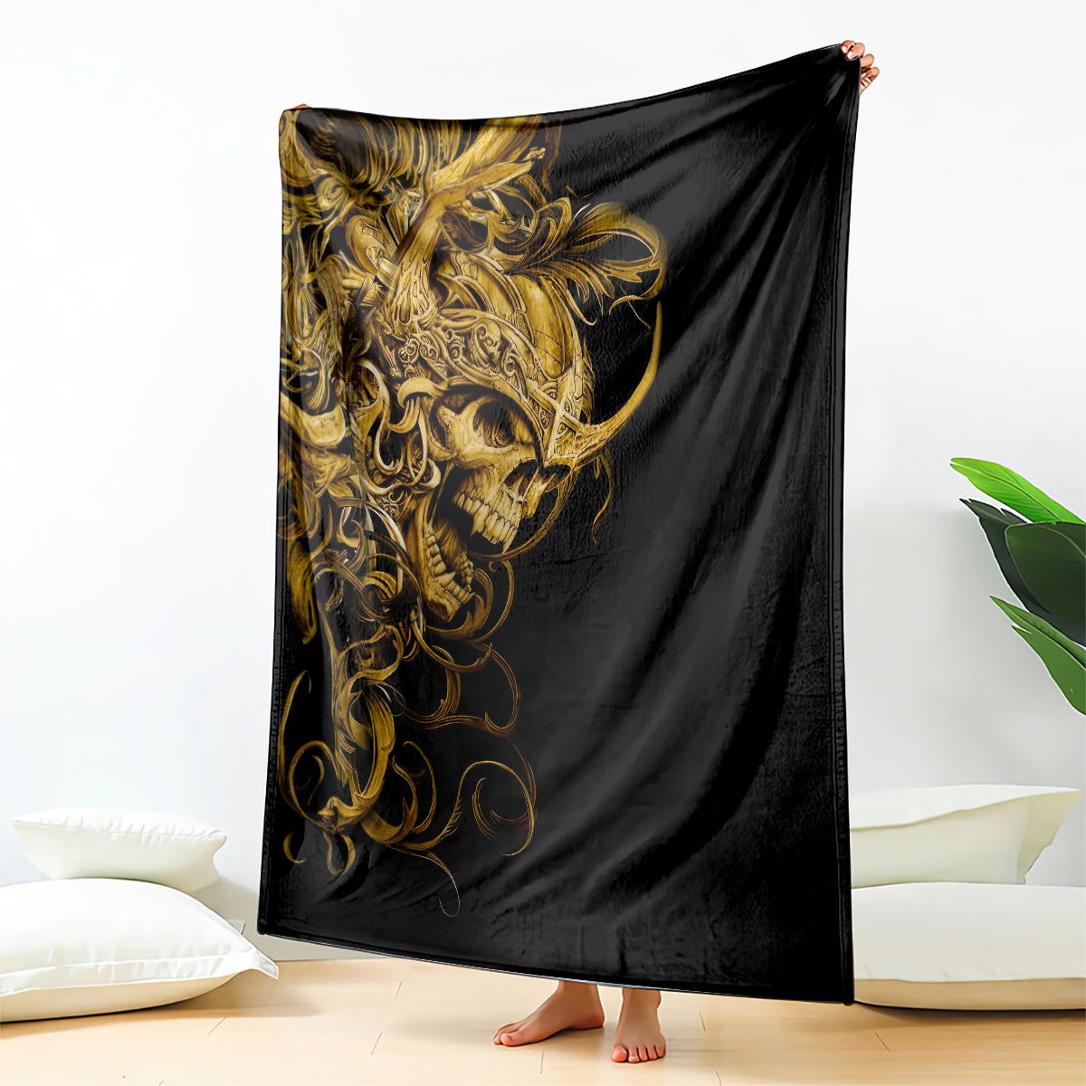 Black skull blanket with ornate gold warrior graphic, draped over bed end