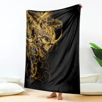 Black skull blanket with ornate gold warrior graphic, draped over bed end