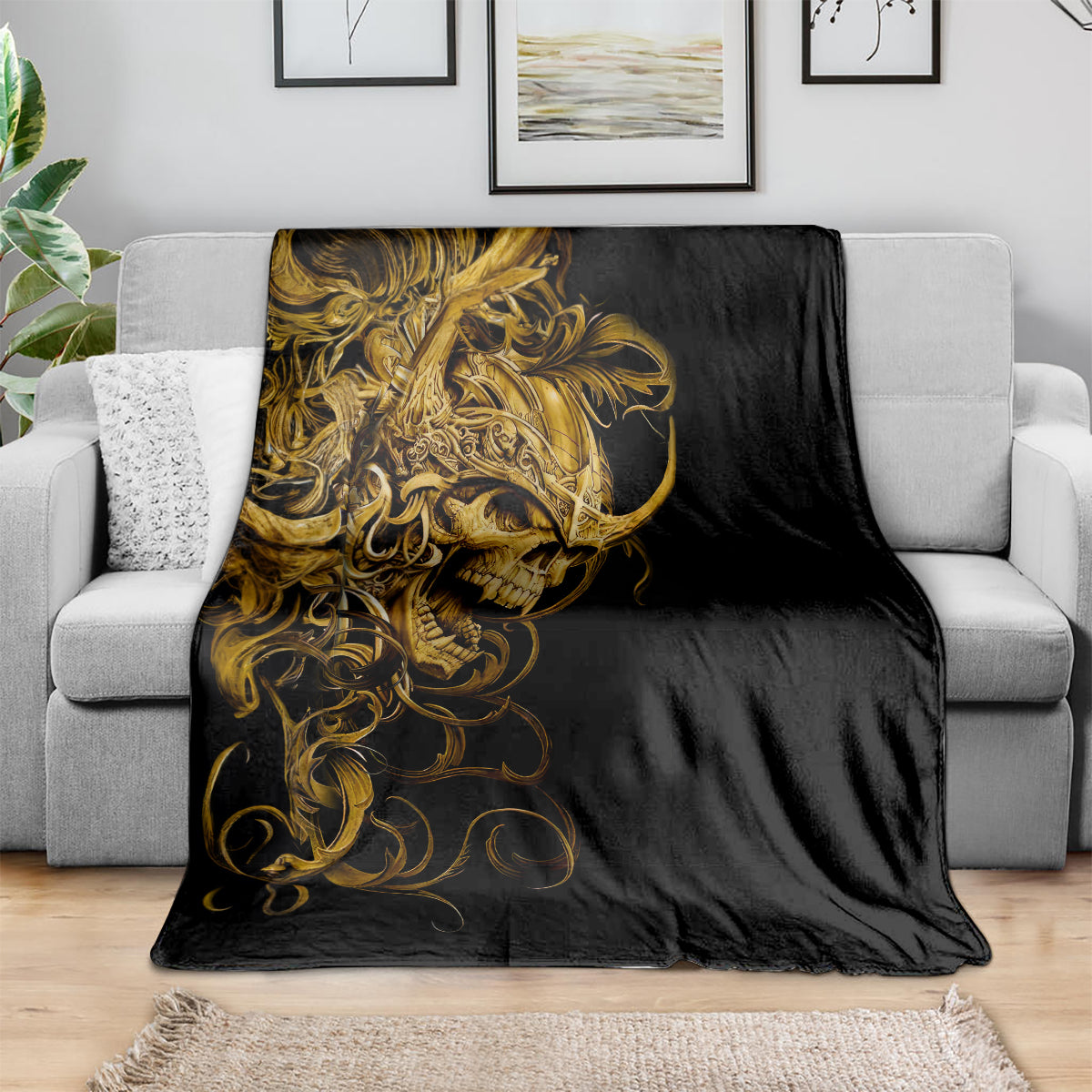 Black skull blanket with gold ornamental warrior face, spread on sofa