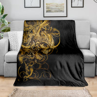 Black skull blanket with gold ornamental warrior face, spread on sofa