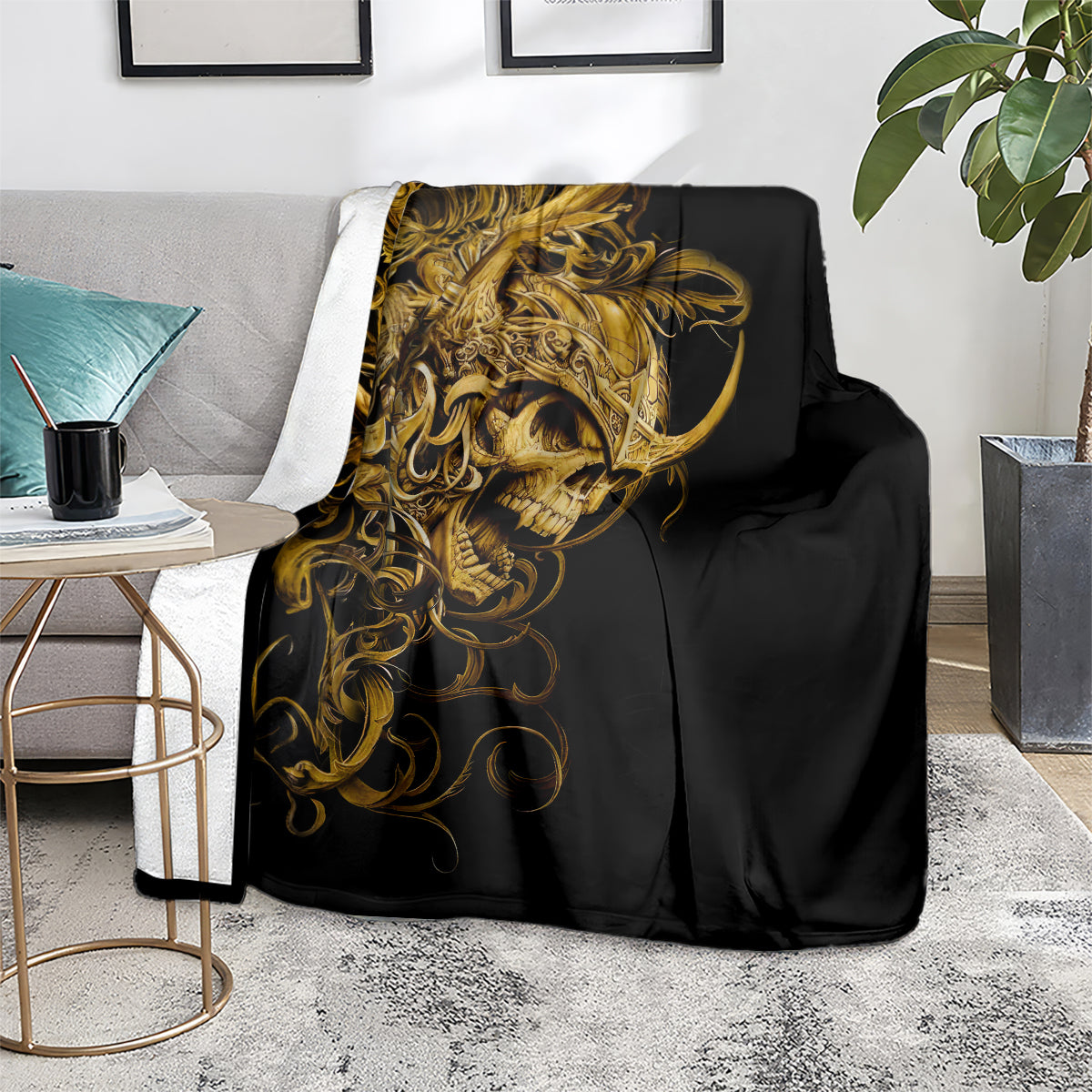 Black skull blanket with gold ornate skull, folded on couch seat