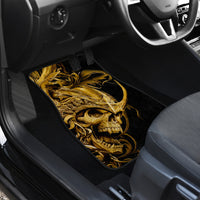 Black car floor mat with golden warrior skull design in the footwell