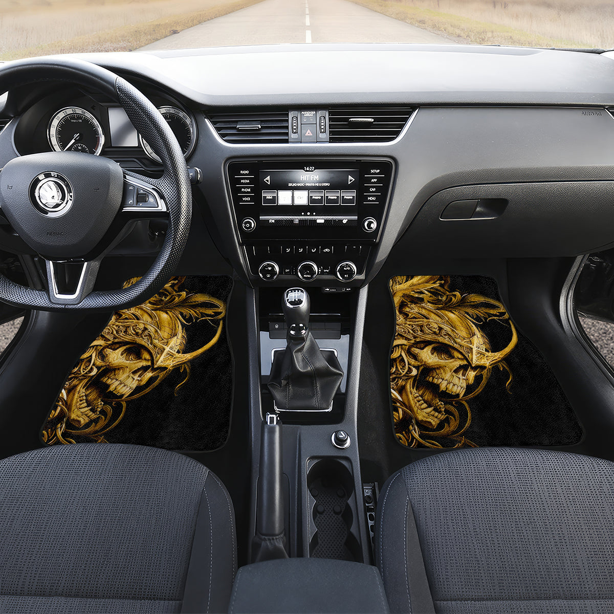 Black car floor mat set with golden warrior skull graphics on both front sides
