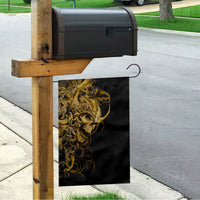 Black house flag with golden skull warrior graphic, shown on wooden post