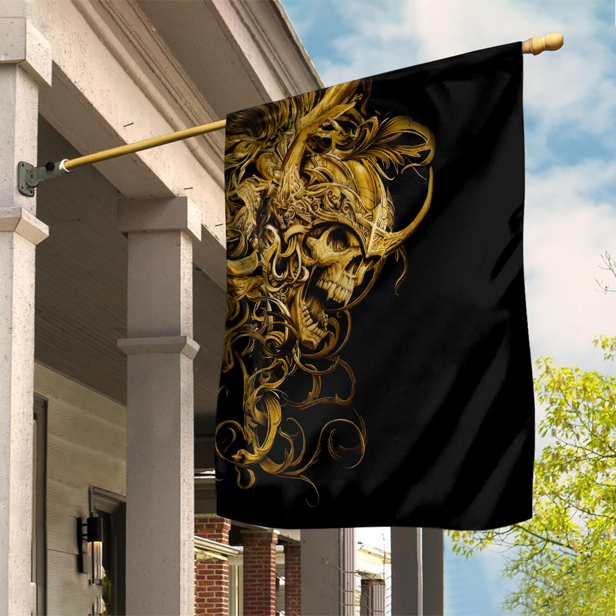 Black garden flag with golden skull warrior artwork hanging on pole
