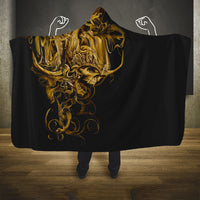 Black skull hooded blanket with gold warrior face graphic, wide cape design