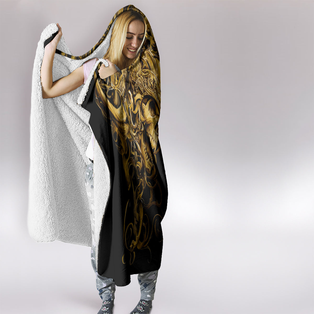Black hooded blanket with gold skull warrior print, cape style with white sherpa trim